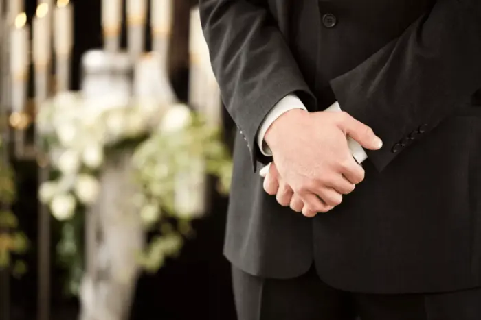 Man with crossed hands - Organising A Funeral 
